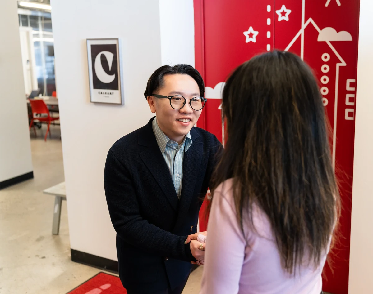 Navora consultant greeting a client in the office